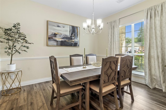 dining space featuring an inviting chandelier and dark wood-type flooring