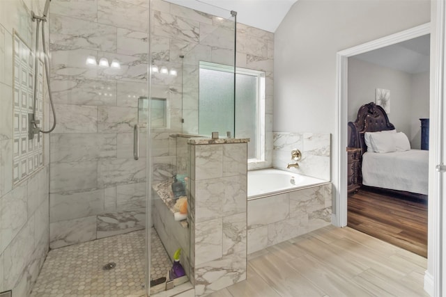 bathroom with independent shower and bath, lofted ceiling, and hardwood / wood-style flooring