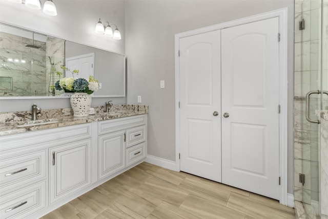 bathroom with vanity and a shower with shower door