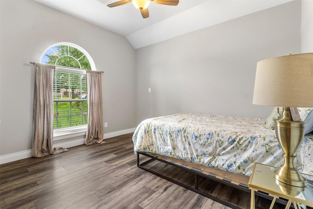 bedroom with ceiling fan, lofted ceiling, and dark hardwood / wood-style floors