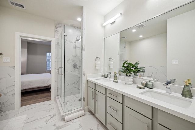 bathroom with a shower with door and vanity