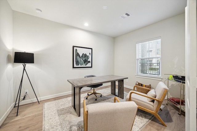 office space with light hardwood / wood-style floors