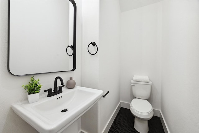 bathroom with tile patterned floors, toilet, and sink