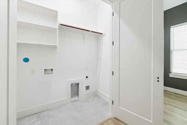 clothes washing area with plenty of natural light, hookup for an electric dryer, and hookup for a washing machine