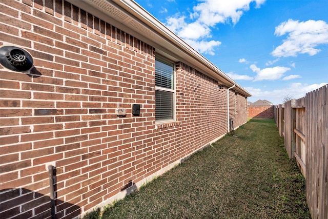 view of side of home featuring a lawn