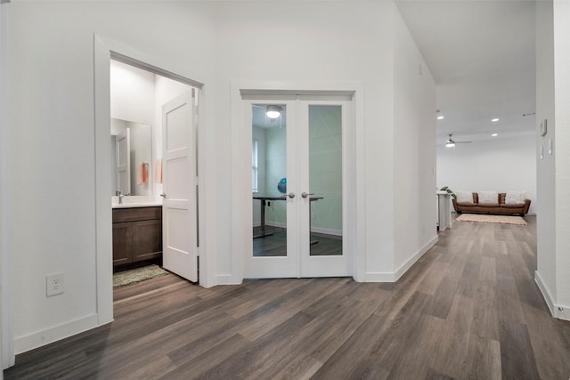 hall with sink, dark hardwood / wood-style flooring, and french doors