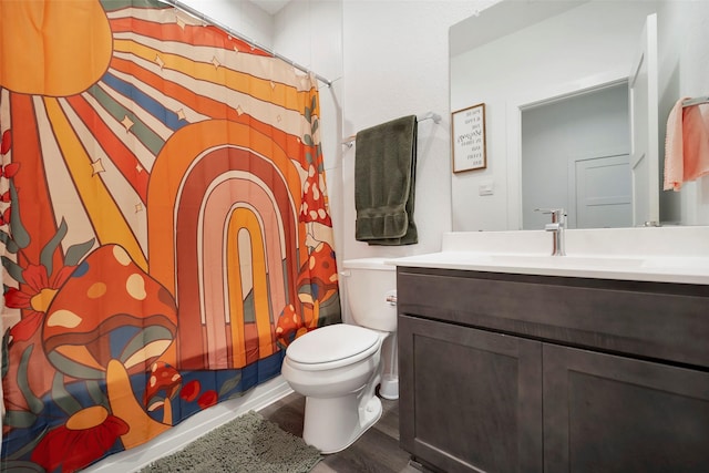 bathroom with vanity, toilet, curtained shower, and hardwood / wood-style floors