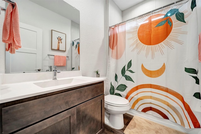 bathroom featuring vanity, hardwood / wood-style floors, and toilet