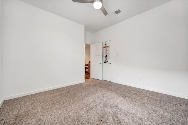 carpeted spare room with ceiling fan