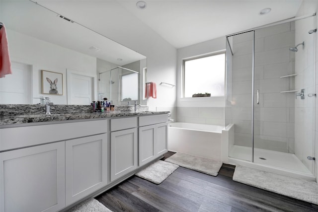 bathroom with vanity, hardwood / wood-style floors, and shower with separate bathtub