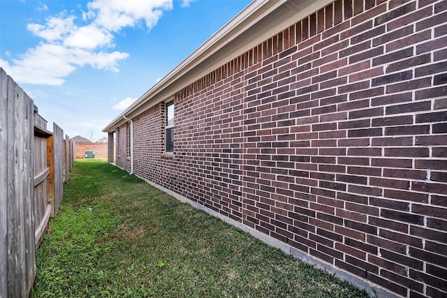 view of side of home featuring a yard