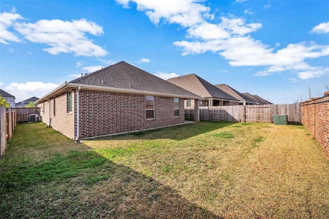 rear view of house featuring a yard