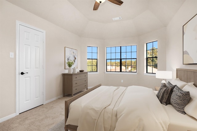 carpeted bedroom with multiple windows and ceiling fan