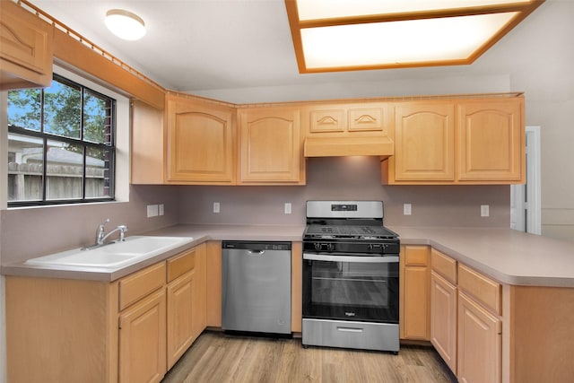 kitchen featuring stainless steel appliances, sink, light brown cabinets, and light hardwood / wood-style floors