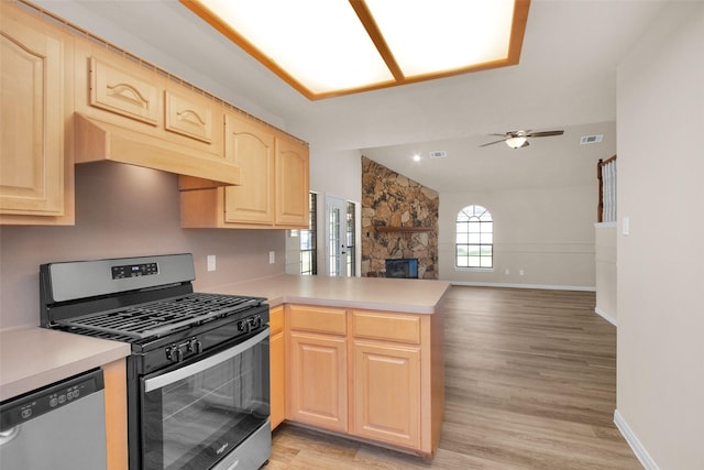 kitchen featuring ceiling fan, appliances with stainless steel finishes, light hardwood / wood-style floors, light brown cabinetry, and kitchen peninsula