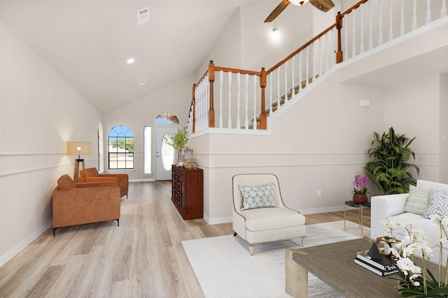 living room featuring high vaulted ceiling, ceiling fan, and light wood-type flooring