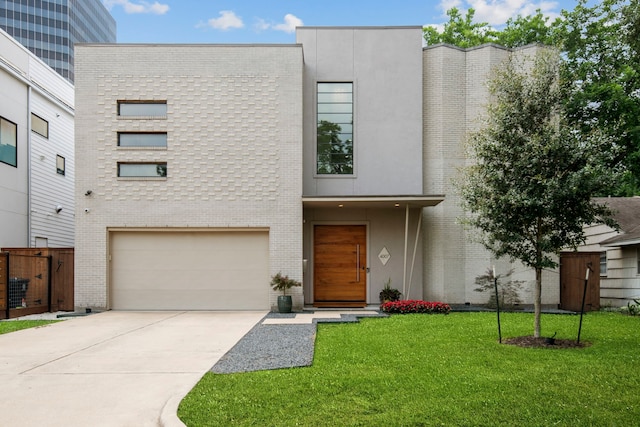 view of front of home featuring concrete driveway, brick siding, and a front yard