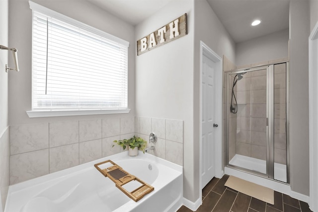 bathroom with separate shower and tub