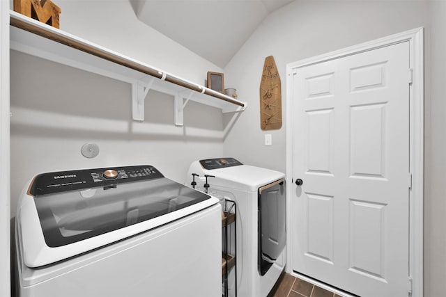 laundry area with dark hardwood / wood-style flooring and washing machine and dryer