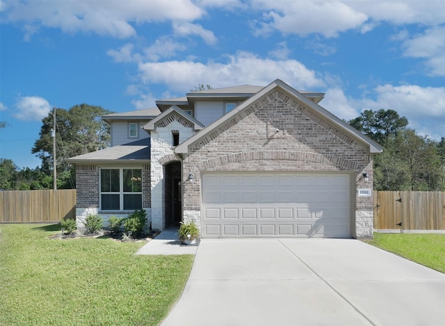 view of front of home featuring a garage and a front yard