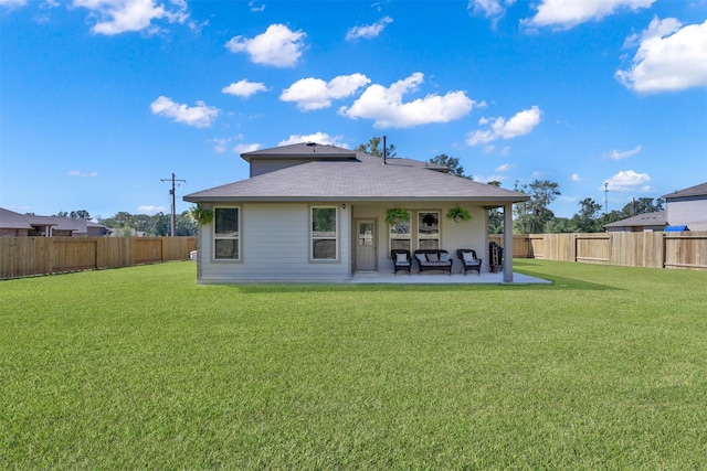 back of property with a patio and a lawn