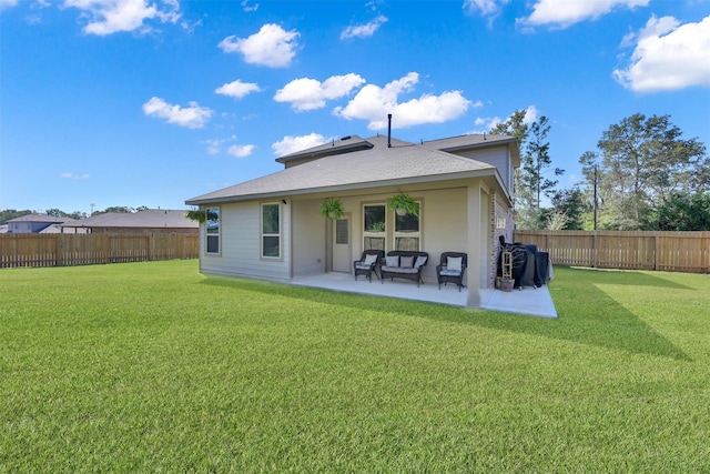 back of property with a patio and a yard