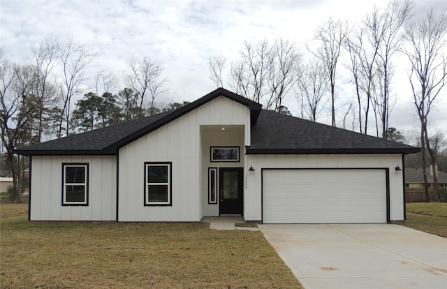 view of front facade with a garage, a front yard, concrete driveway, and a shingled roof