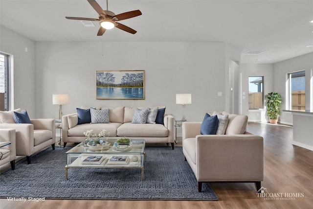 living room with ceiling fan, visible vents, a healthy amount of sunlight, and wood finished floors