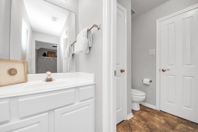 bathroom with vanity and toilet