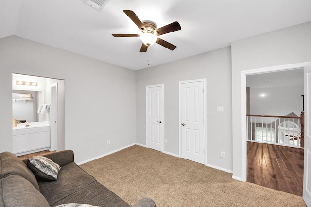 carpeted living room with vaulted ceiling and ceiling fan