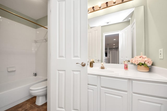 full bathroom with tiled shower / bath, tile patterned floors, toilet, and vanity