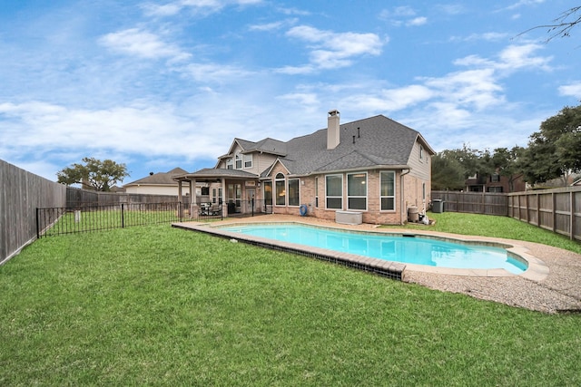 view of pool with a yard and a patio area