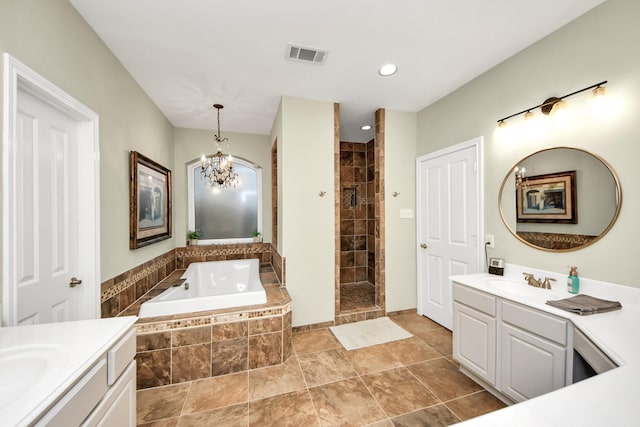 bathroom with vanity, shower with separate bathtub, and an inviting chandelier