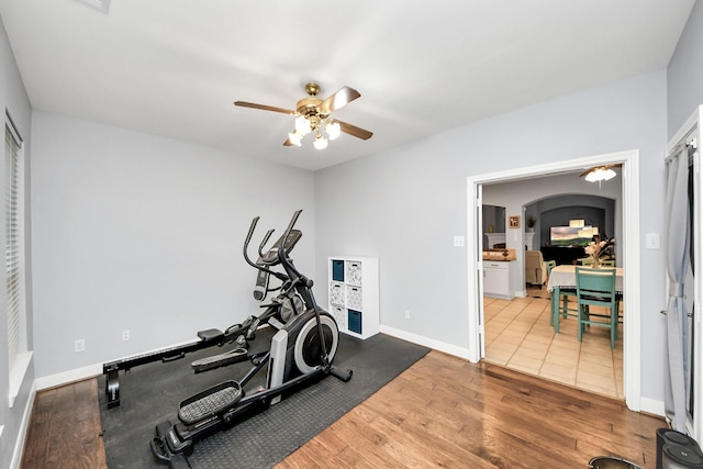 exercise room with wood-type flooring and ceiling fan