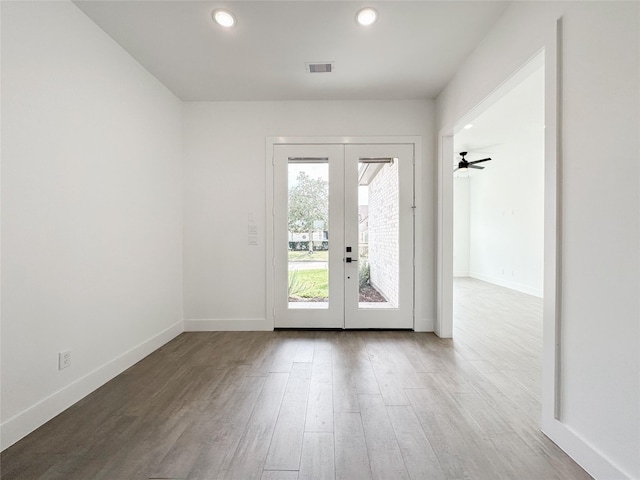 doorway to outside with hardwood / wood-style flooring, ceiling fan, and french doors