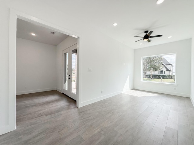 unfurnished room featuring ceiling fan and light hardwood / wood-style flooring