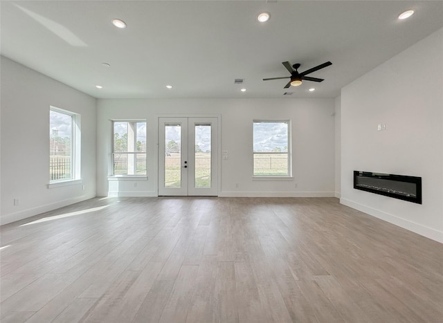 unfurnished living room with light hardwood / wood-style floors, french doors, and ceiling fan