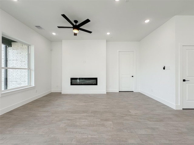 unfurnished living room with ceiling fan and light hardwood / wood-style flooring