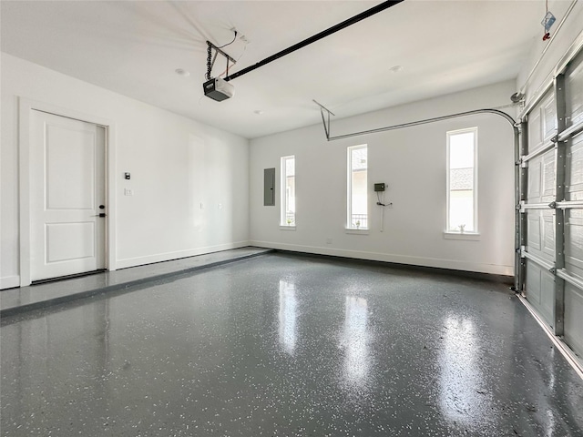 garage with a garage door opener and electric panel