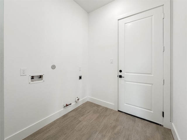 laundry area featuring gas dryer hookup, light hardwood / wood-style floors, hookup for a washing machine, and electric dryer hookup