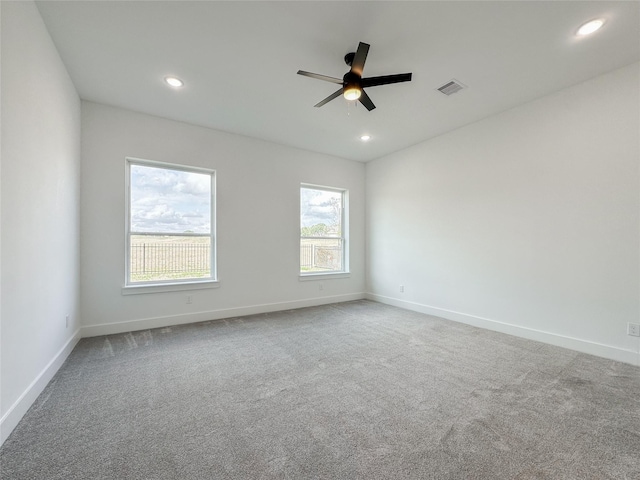 carpeted empty room featuring ceiling fan