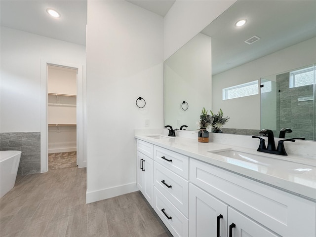 bathroom featuring vanity, shower with separate bathtub, and hardwood / wood-style floors