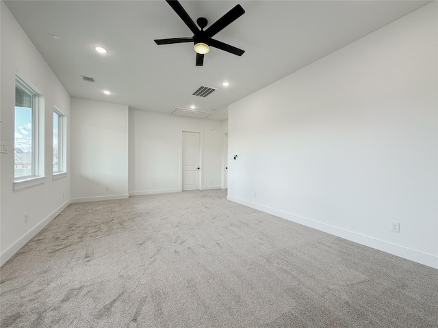 spare room featuring light carpet and ceiling fan