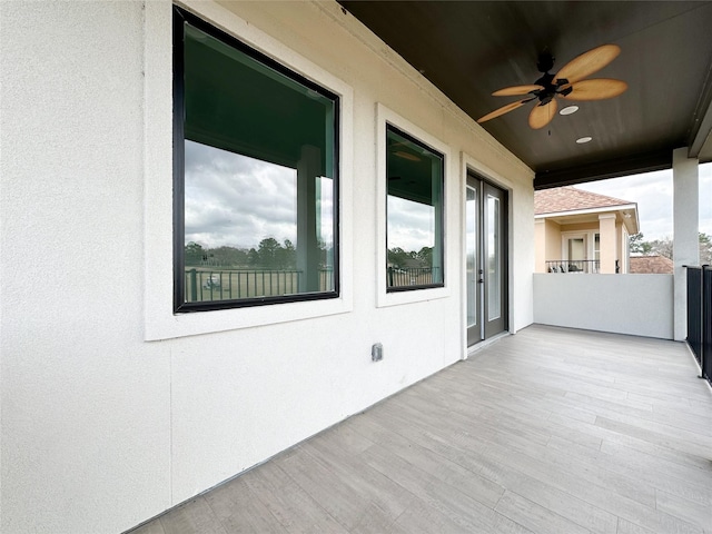 view of patio / terrace with a balcony and ceiling fan