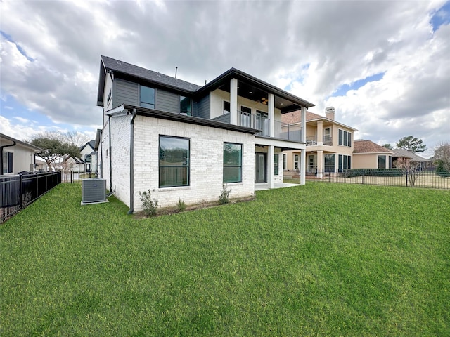 back of house with a balcony, central AC unit, and a lawn