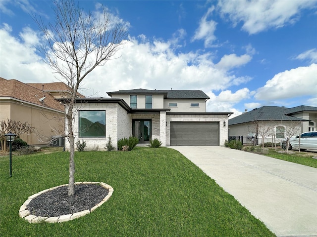 view of front of home featuring a garage and a front yard