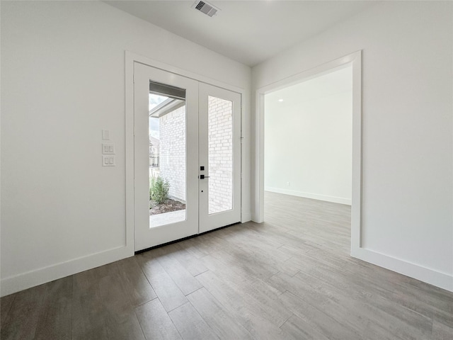 entryway with french doors and light wood-type flooring