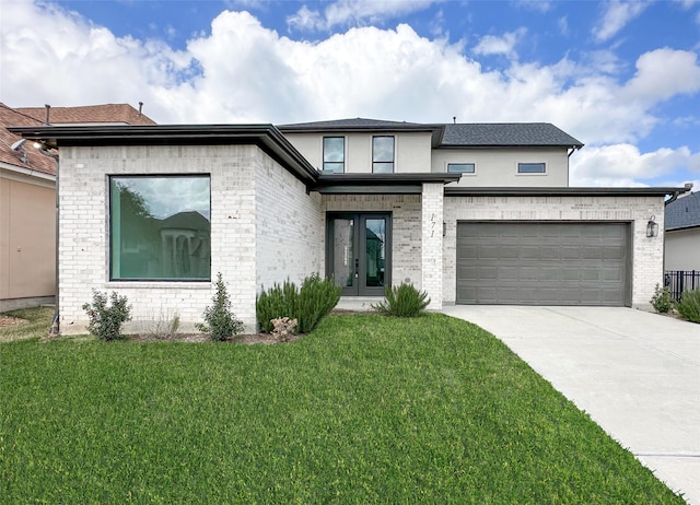 view of front of home with a garage, a front lawn, and french doors