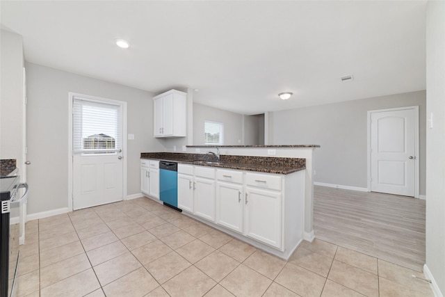 kitchen with white cabinetry, stainless steel dishwasher, dark stone counters, and kitchen peninsula