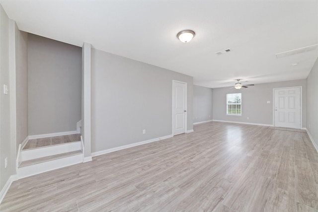 spare room with ceiling fan and light wood-type flooring